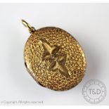 A yellow metal oval locket with ivy leaf detail, apparently unmarked, within Lowe and Sons,