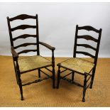 A set of four beech and ash ladder back dining chairs, including two with arms, with rush seats,