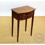 An Edwardian mahogany bow front side table, with two drawers, on tapered legs,