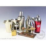 A selection of Art Deco type silver plated and chromed wares include cocktail shakers,