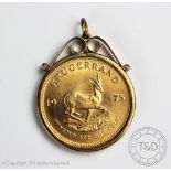 A gold South African Krugerrand dated 1975, within a 9ct gold pendant mount, gross weight 38.