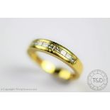 A diamond set half eternity ring, the 18ct yellow gold ring,