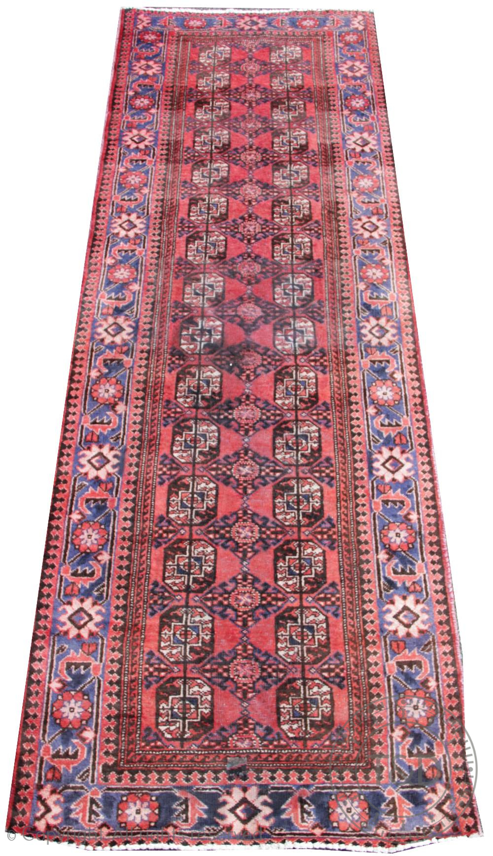 A Caucasian Bokhara wool runner, worked against a red ground,