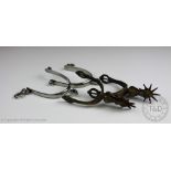 A pair of cast and chased brass spurs, 16cm,