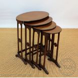 An Edwardian mahogany quartetto nest of tables, with graduating tops from oval to circular,
