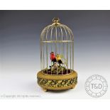 A continental singing bird automaton, modelled with two birds under a brass case,