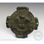 A Shropshire and North Wales pressed fire mark, with central fleur de lis and scroll details,