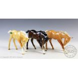 Three Beswick foals (large, head down), model number 947, designed by Arthur Gredington,