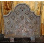 A cast iron fire back, decorated with Fleur-de-lis, 50cm x 53cm,