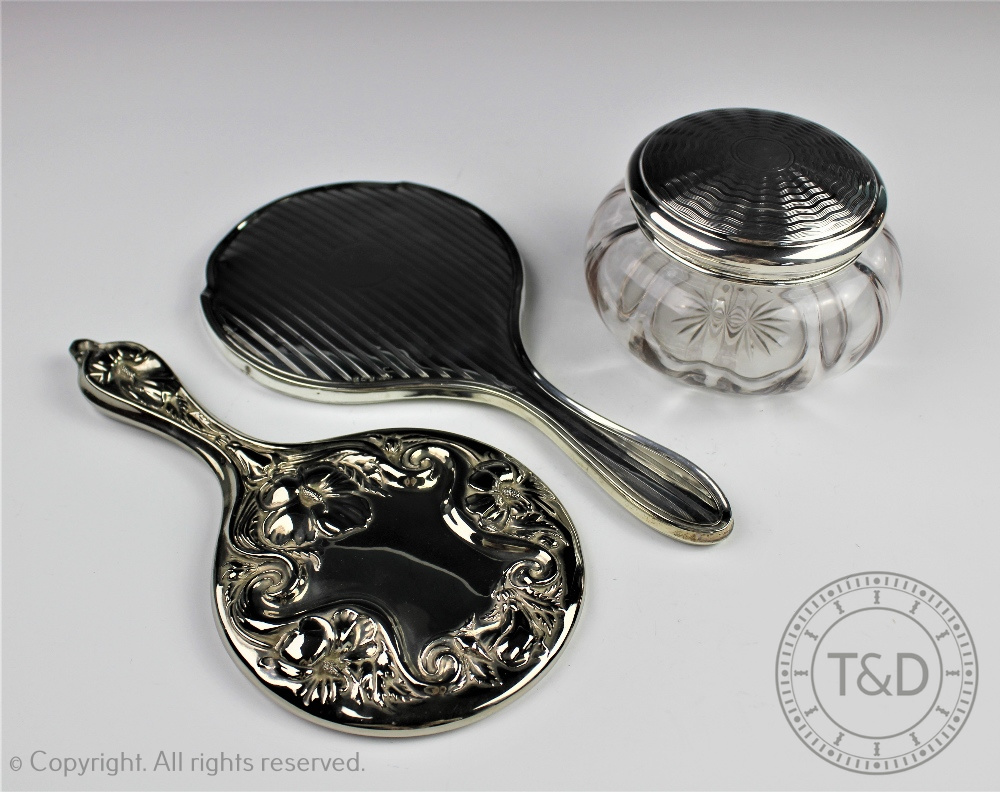 A George V silver hand mirror, Birmingham 1924, 26cm, with a similar silver and glass powder jar,