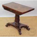 A Victorian mahogany fold over tea table, with a lappet carved column, on platform and scroll legs,