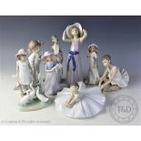 A Lladro figure of a maiden in a bonnet, 26cm, a smaller Lladro figure of a woman holding a hat,