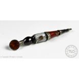 A Scottish style hardstone pin dirk brooch, set with a cabochon garnet coloured stone,