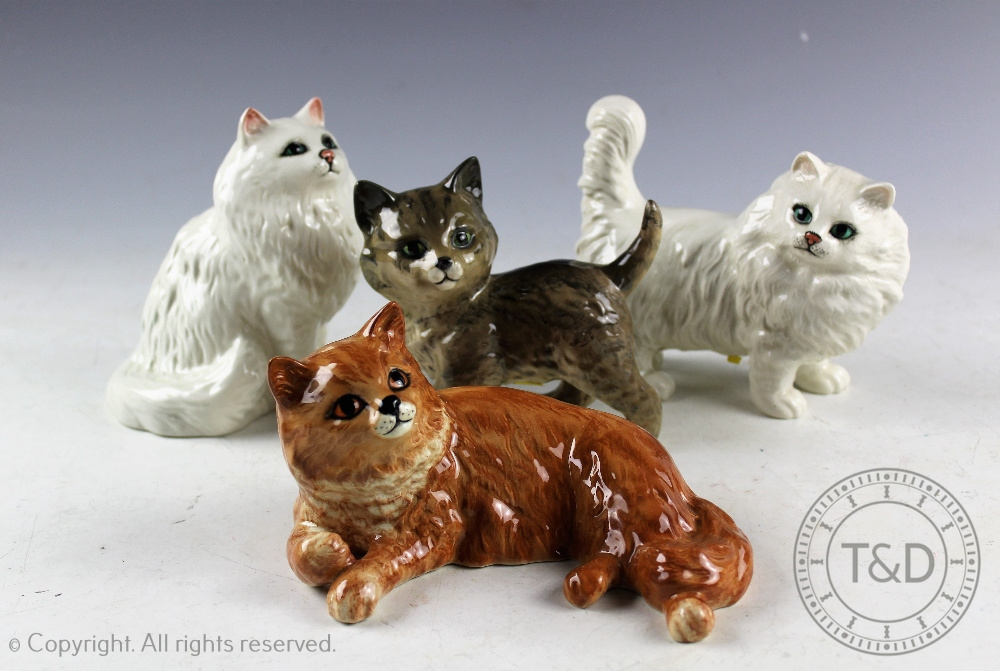 A collection of four Beswick cats, to include; Persian kitten standing, model number 1885, in grey,