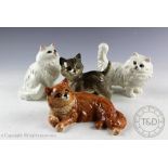 A collection of four Beswick cats, to include; Persian kitten standing, model number 1885, in grey,