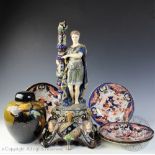 A large Continental majolica figural candlestick, modelled as a warrior standing beside a column,