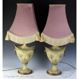 A pair of modern toleware style lamps, with floral detailing, with a pair of pink shades,