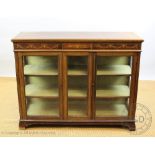 An Edwardian inlaid mahogany display cabinet, with two glazed doors and a central panel,