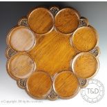 A Victorian carved oak lazy susan, the eight section top embellished with flowers,