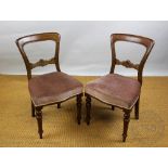 A set of four Victorian carved walnut dining chairs, with pale red upholstered seats,