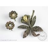 A silver and marcasite set floral brooch in the form of an orchid and a matched pair of marcasite