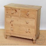 A Victorian pine chest, of two short and two long drawers, on bun feet,