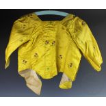 A late 18th century canary yellow satin ladies bodice with floral embroidery,
