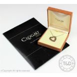 A Clogau heart shaped pendant, the silver outer heart with gold scroll design interior,