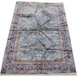 A Kashmir tree of life rug, worked with a design of flowers and animals against a blue ground,