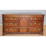 A George III oak and mahogany crossbanded mule chest, with hinged top above four dummy drawers,