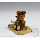 A Schuco type miniature bear, with bead eyes, felt paws and ears, 6.