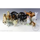 A collection of nine Royal Dux figures and figural groups to include two seated dogs, 21cm high,