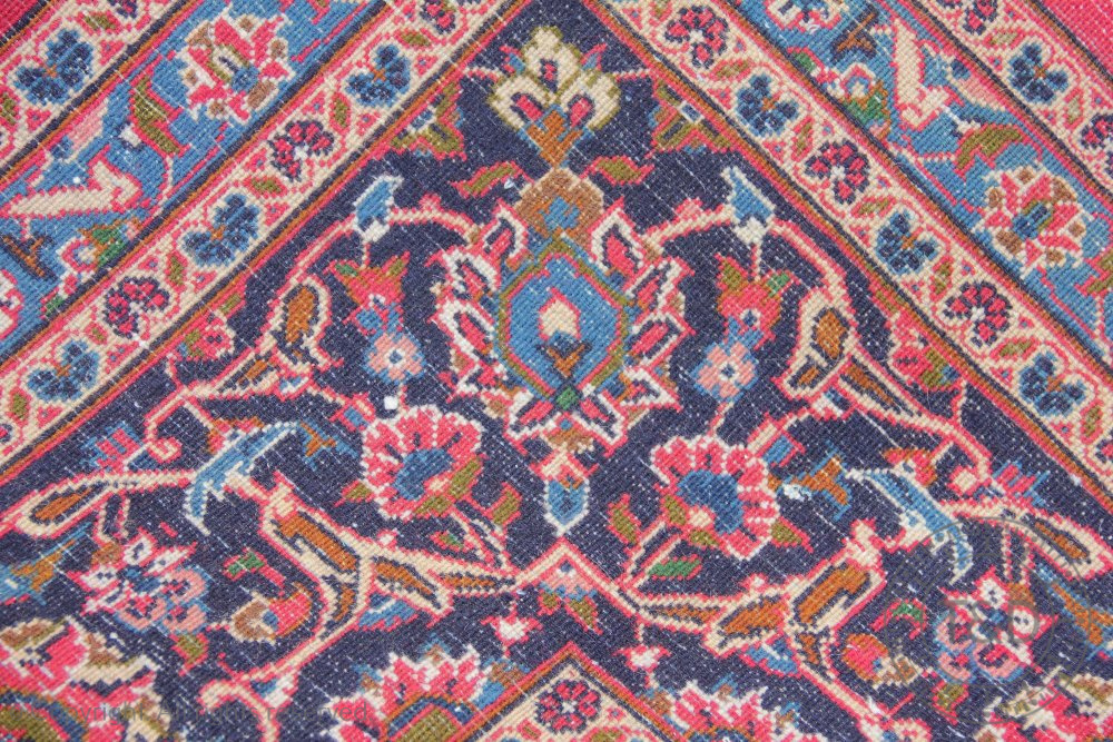 A large Persian Kashan wool carpet, worked with an all over floral design against a red ground, - Bild 3 aus 3