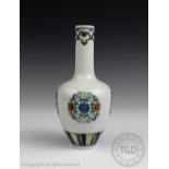 A small Chinese porcelain doucai bottle vase, decorated with repeated roundels of Shou symbols,