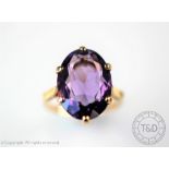 An amethyst set dress ring, the oval,