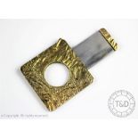 A 9ct gold cigar cutter, London 1976, of rounded square form and with textured design,