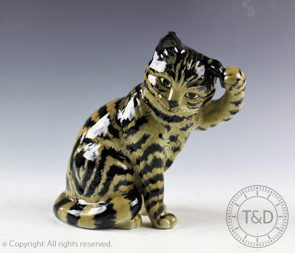 A Beswick Cat - seated scratching ear, model number 1877, in grey swiss roll,