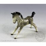 A Beswick foal (small, stretched, facing right), model number 815, designed by Arthur Gredington,