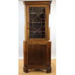 A George III mahogany corner cabinet, with astragal glazed door above a cupboard door,