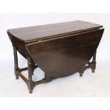 A late 17th / early 18th century oak gate leg table, on turned and block legs,