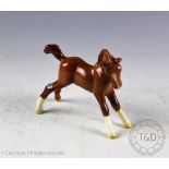 A Beswick foal (small, stretched, facing right), model number 815, designed by Arthur Gredington,