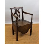 A George III country oak commode chair, with pierced splat, on tapered legs,