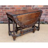 An 18th century and later carved oak gate leg table, on turned and block legs,