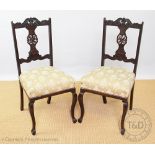 A set of four Edwardian carved and stained beech dining chairs by Gamlins,