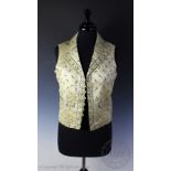 An early 19th century floral embroidered cream satin waistcoat,