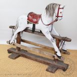 An early 20th century Ayres rocking horse, dappled grey with leather saddle, on turned pine base,