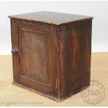 A stained pine spice cupboard, with panelled door enclosing six drawers,