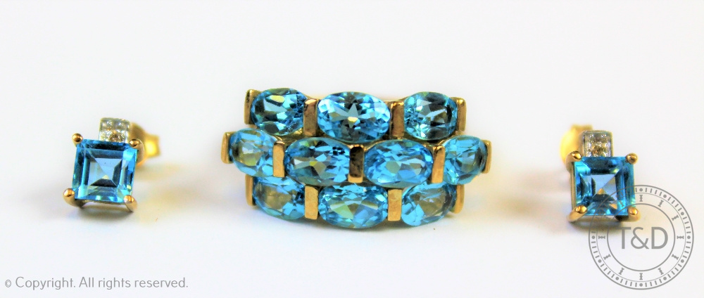 A blue topaz set dress ring with matched diamond and topaz earrings,