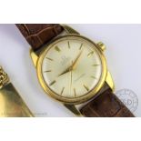 A gentlemans 18ct gold Omega Automatic Seamaster wristwatch, the champagne dial with batons,