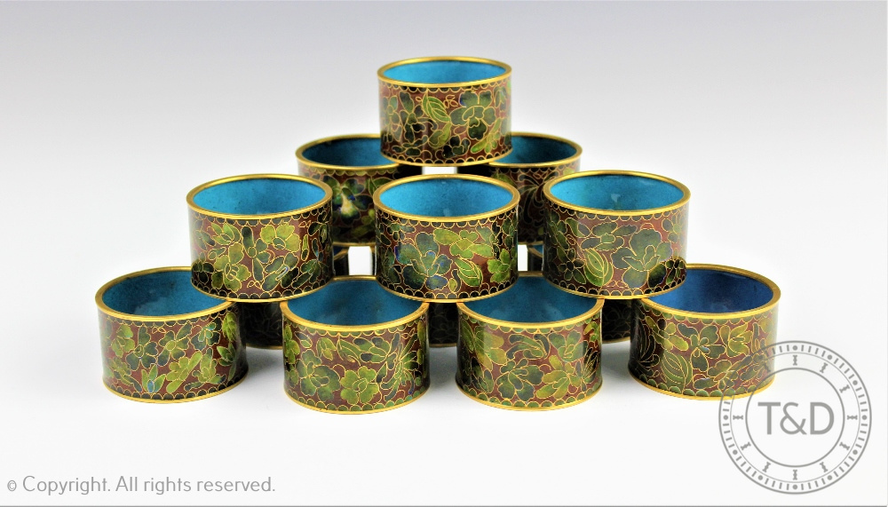 A near set of ten Japanese cloisonne enamel napkin rings, decorated with flowers,
